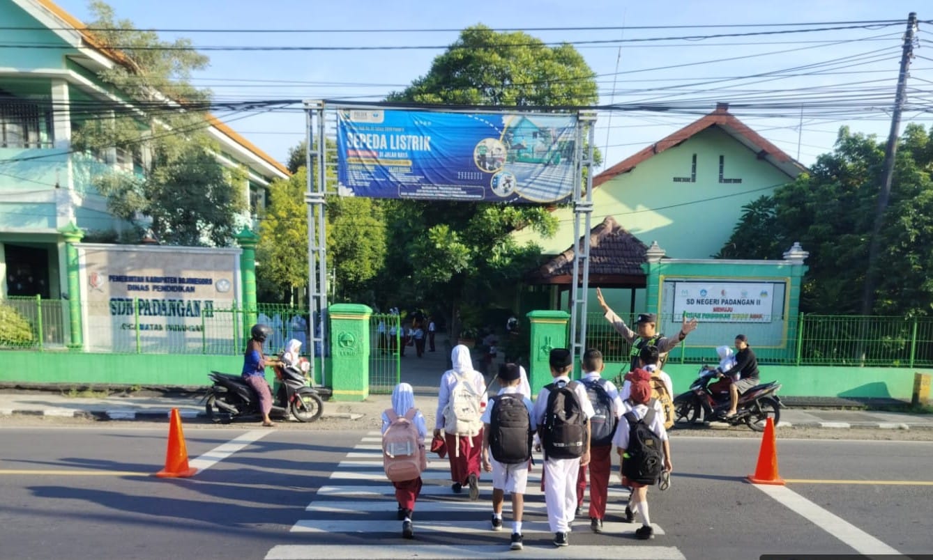 Hadir untuk Manfaat, Personil Polsek Padangan Bantu Anak Sekolah Menyeberang Jalan