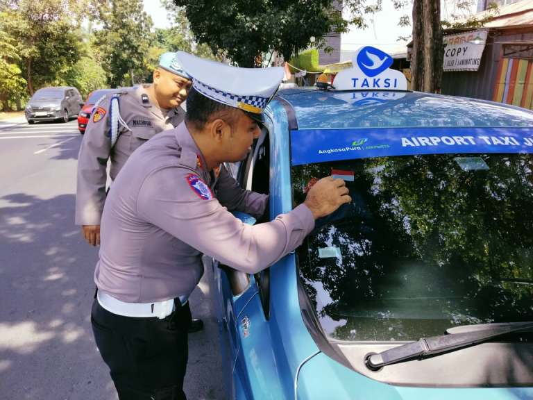 Meriahkan HUT RI ke-80, Polsek Wonocolo Bagikan Bendera Merah Putih kepada Pengendara